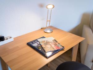 a table with a book and a lamp on it at Apartment B901 by Interhome in Lahnstein