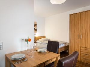 a dining room with a table and a bed at Apartment A707 by Interhome in Lahnstein