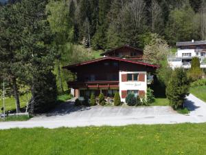 a house in the mountains with a driveway at Holiday Home Hussl by Interhome in Fügenberg