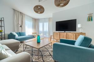 Μια τηλεόραση ή/και κέντρο ψυχαγωγίας στο Przy Plaży - City Apartments +7 φωτογραφίες