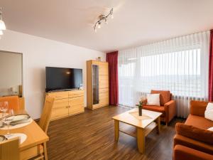 ein Wohnzimmer mit einem Sofa und einem TV in der Unterkunft Apartment B1013 by Interhome in Lahnstein