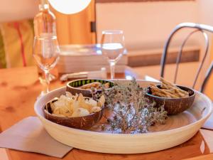 a plate of food on a table with wine glasses at Holiday Home La Chênaie - ORN309 by Interhome in Oraison