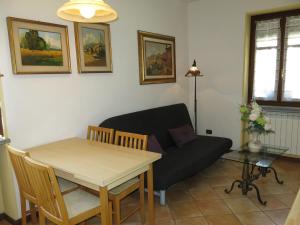 a living room with a table and a couch at Holiday Home I Grilli by Interhome in Castagnole Lanze