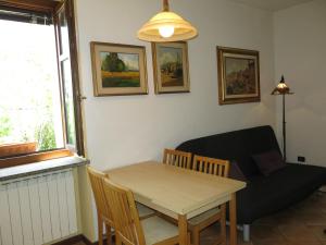 a living room with a table and a couch at Holiday Home I Grilli by Interhome in Castagnole Lanze +16 photos