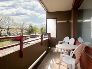 a balcony with a table and chairs and a window at Apartment A109 by Interhome in Lahnstein
