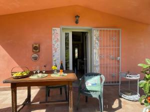 a patio with a wooden table and chairs at Holiday Home Casa dei Nonni - IMP425 by Interhome in Imperia