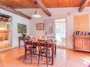 a dining room with a table and chairs at Holiday Home L'Amandier - ORN310 by Interhome in Oraison