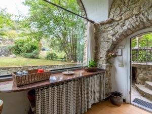 a kitchen with a window and a stone wall at Holiday Home Muin du Pie - SLR120 by Interhome in San Lorenzo al Mare