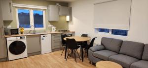 a kitchen and living room with a couch and a table at Peacock Farms Estate in Cork +14 photos