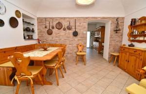 a kitchen and dining room with a wooden table and chairs at iL GeLsoMiNo in Brandizzo