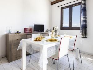 a white dining room with a white table and chairs at Apartment Les Frégates-15 by Interhome in Saint-Cyprien +23 photos