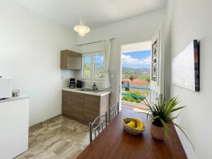 a kitchen with a table with bananas on it at Odysseas Apartments in Marathokampos