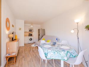 a dining room with a table and chairs in a room at Apartment Régina-13 by Interhome in Sainte-Maxime