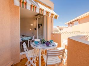 a patio with a table and chairs on a balcony at Apartment Régina-13 by Interhome in Sainte-Maxime