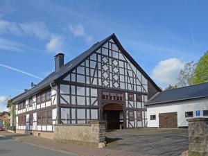 a large white building with a black roof at Apartment Atelier an der Kirche by Interhome in Hohe