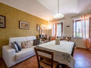 a living room with a white couch and a table at Holiday Home Agriturismo I Tre Tigli by Interhome in Serravalle dʼAsti