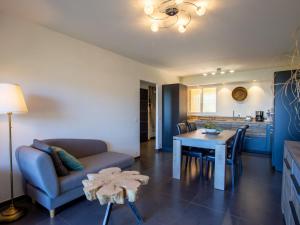 a living room with a couch and a table at Apartment Un autre jour ensoleillé by Interhome in Bormes-les-Mimosas