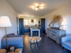 a living room with a couch and a table at Apartment Un autre jour ensoleillé by Interhome in Bormes-les-Mimosas