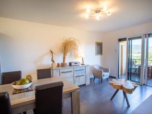 a dining room with a table and chairs and a dining room at Apartment Un autre jour ensoleillé by Interhome in Bormes-les-Mimosas