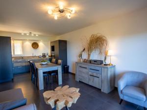 a living room with a table and a kitchen at Apartment Un autre jour ensoleillé by Interhome in Bormes-les-Mimosas +17 photos