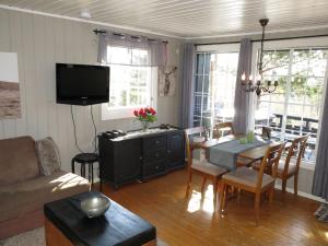 a living room with a table and a dining room at Holiday Home Evabu - SOW069 by Interhome in Øyuvstad