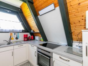 a kitchen with a sink and a stove at Holiday Home Fedderwardersiel-5 by Interhome in Fedderwarderdeich