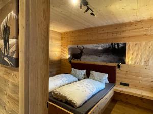 a room with a bed in a log cabin at Apartment Eberharter-5 by Interhome in Aschau