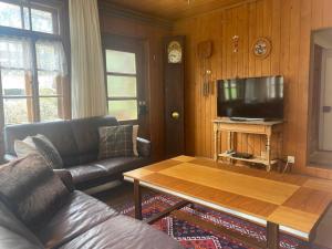 a living room with a couch and a coffee table at Apartment Chalet Stöckli by Interhome in Kandersteg