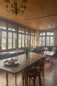 a living room with a large wooden table and chairs at Apartment Chalet Stöckli by Interhome in Kandersteg