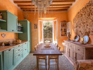 a kitchen with a wooden table in a room at Apartment Trilocale dell'Arco by Interhome in Massa Marittima