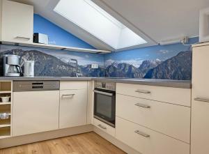 a kitchen with mountains painted on the wall at Alpschatz Adlerhorst in Oberstdorf
