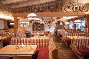 - un restaurant avec des tables et des chaises en bois dans une chambre dans l'établissement Hotel Waidachhof, à Kössen
