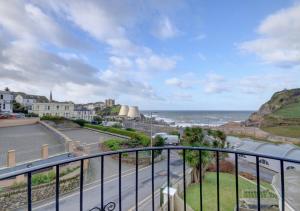 a view of the ocean from a balcony at 7 Cove View in Ilfracombe