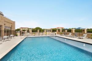 a large swimming pool with chairs at Hyatt Place Fort Worth/TCU in Fort Worth