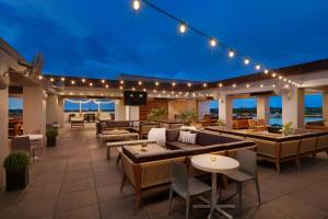 a patio with tables and chairs and lights at Hyatt Place Fort Worth/TCU in Fort Worth