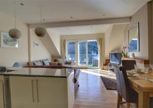 a kitchen and living room with a table and chairs at Aberlyn in Lynmouth