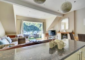a kitchen and living room with a large window at Aberlyn in Lynmouth