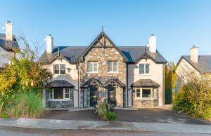 a large brick house with a driveway at Foleys Ardmullen Townhouses in Kenmare