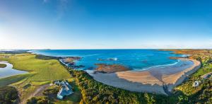 an aerial view of a beach and the ocean at 1-bedroom unit with balcony and ocean views! in Smiths Beach