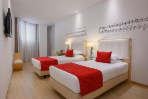 Ένα ή περισσότερα κρεβάτια σε δωμάτιο στο Hotel da Música