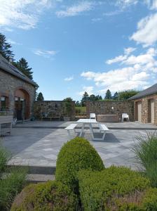 a courtyard with benches and a brick building at Bidi's Lodge in Stavelot