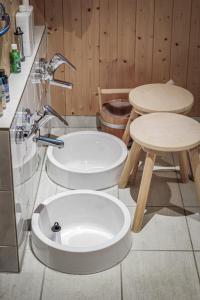 a bathroom with two toilets and a sink at Gästehaus Elfriede in Haldensee