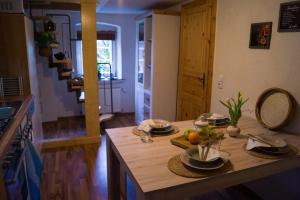 a kitchen with a table with a bowl of fruit on it at Ferienwohnung Zum Jehöschnis in Gerolstein