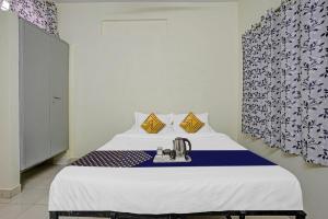 a hospital room with a bed with a sink at SPOT ON Hotel Sk Star in Nagpur