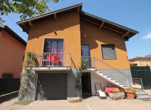 uma casa com uma varanda e um pátio em Beb da Gaia e Giulio em Reno Di Leggiuno