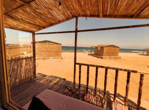 a room with a view of the beach and the ocean at New Droub Camp in Nuweiba