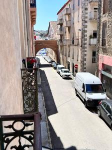 vistas a una calle con coches aparcados y un puente en Hotel Restaurant Les Paquebots, en Port-Vendres