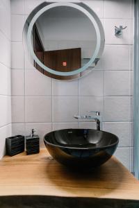 a bathroom with a black sink and a mirror at Zandre shiny apartment in Nea Potidaea +16 photos