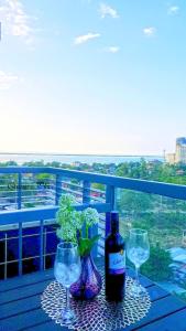 a table with two glasses and a bottle of wine at Mactan Newtown - 1BR Stunning Ocean View and City View in Mactan