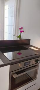 a vase with a flower sitting on top of a counter at Boutique apartment Alla Dolce Vita in Vicenza